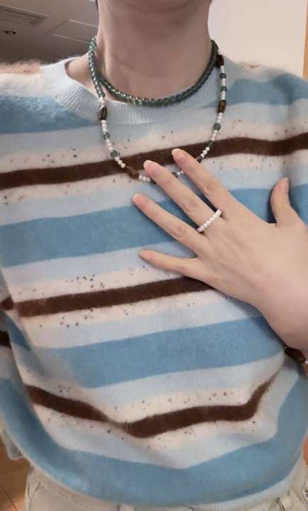 Necklace layered as a choker with pearl ring detail