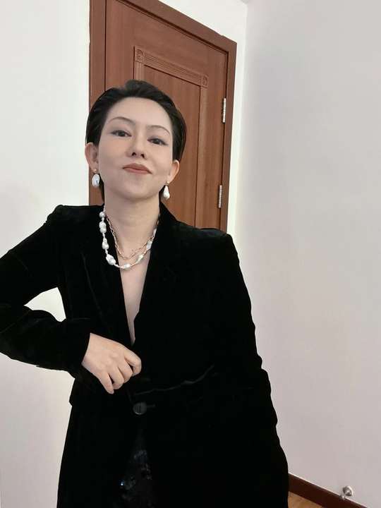 Pearl necklaces doubled with black tailoring