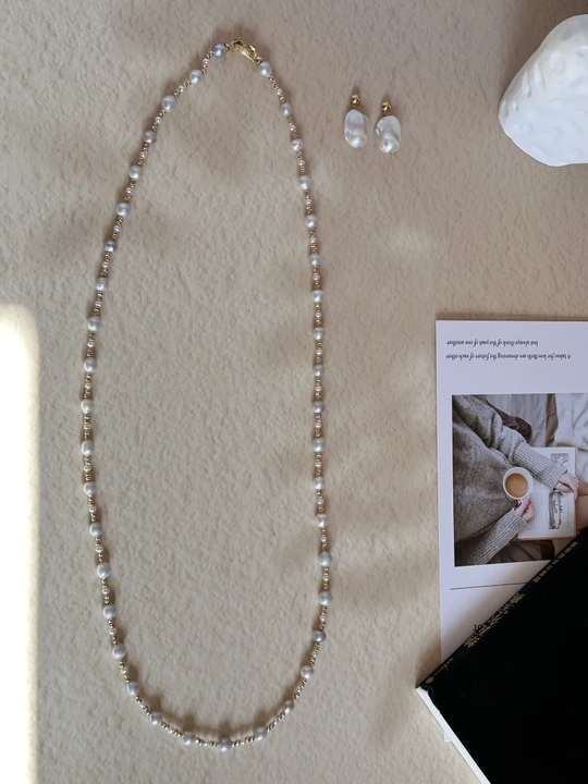 Long freshwater pearl sweater necklace in a warm still life