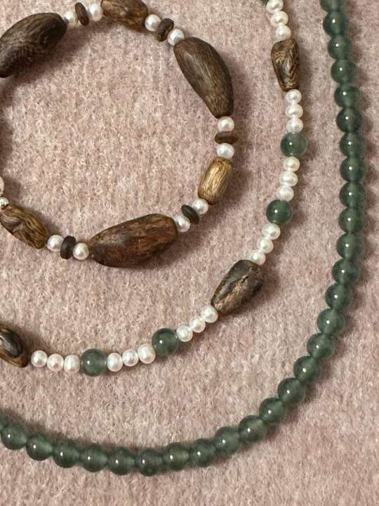 Close-up of qinan agarwood nuggets with blue-water jade and freshwater pearls