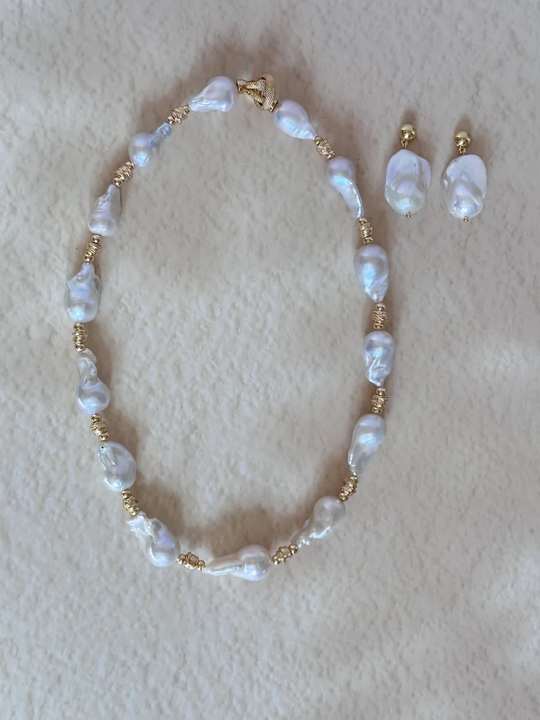 Baroque pearl necklace and earrings arranged together