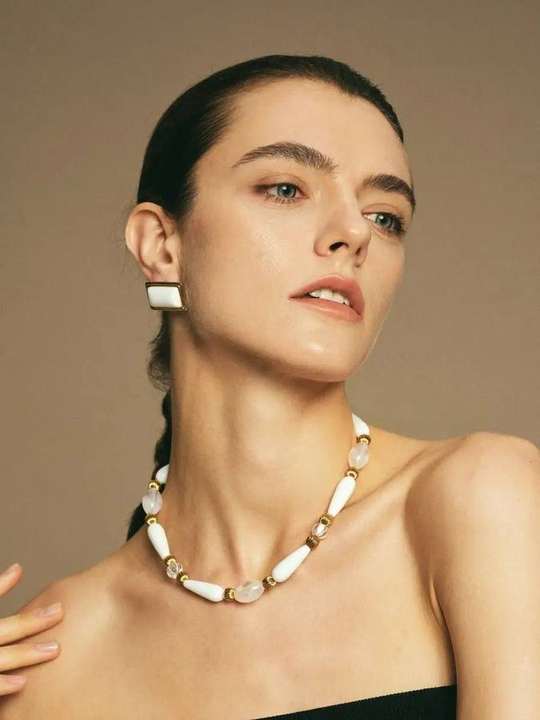 White agate choker and stud earrings in a sculptural pose