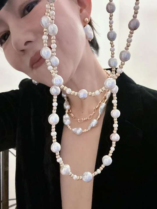 Layered freshwater and baroque pearl necklaces in close-up