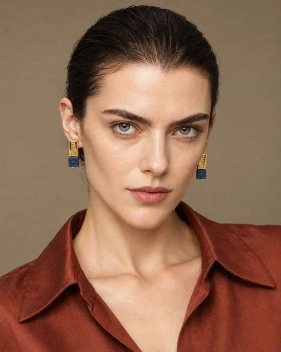 Lapis statement earrings worn by model in rust tailoring