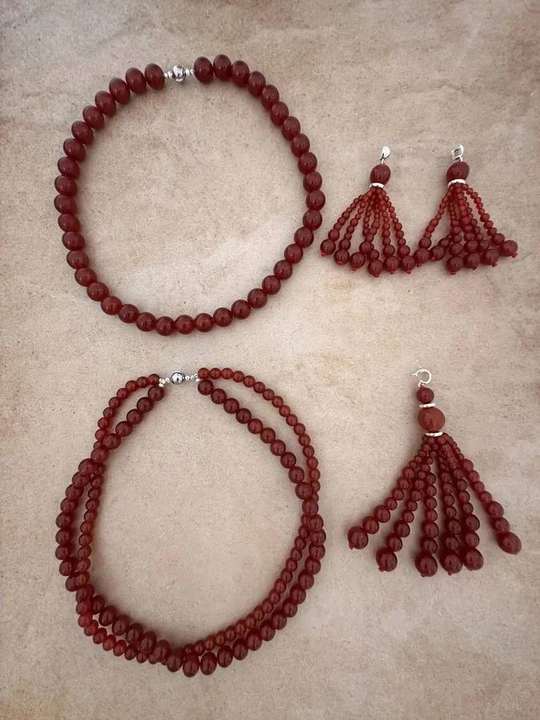 Red agate necklace and earrings laid out
